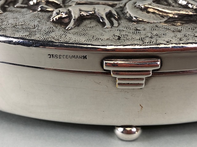 Danish white metal toilet or trinket box, oval shape on bun feet the lid embossed with a drunken - Image 6 of 7