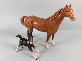 Beswick, Arabic horse with swish back tail marked Beswick to underside and a foal, with unreadable