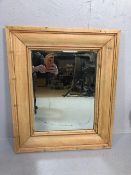 Antique bevel edged mirror in a wide stripped Pine frame approximately 55 x 65cm