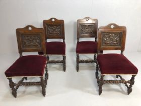 Antique furniture, four oak chairs with carved armorial style backs and padded seats on barley twist