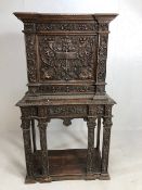 Heavily carved square cupboard on stand, carved with inscription "Venetia", cupboard with fall
