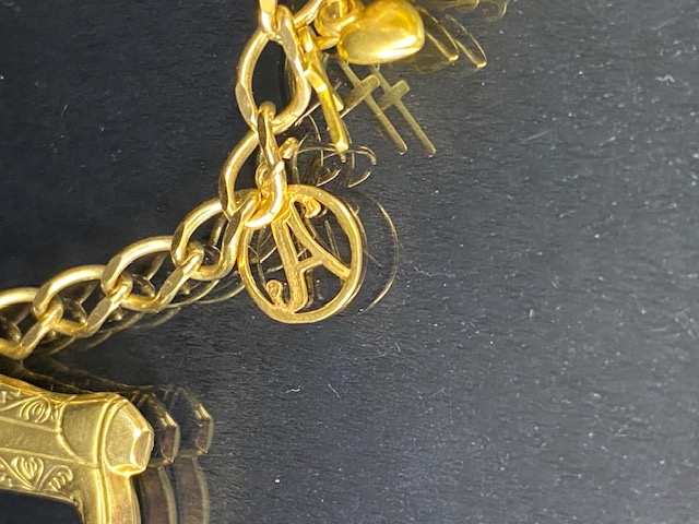 9Ct Gold charm bracelet with a collection of 9ct gold charms, to include, rabbit, Dolphins, Boot, - Image 7 of 9
