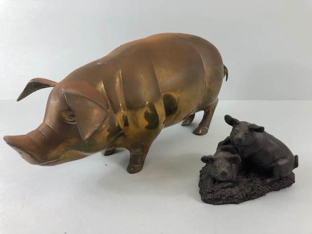 Vintage whimsical figure of a pig in brass approximately 36 x 14cm along with a cold cast bronze