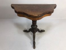 Antique folding card table with book match veneer, on carved tripod base opening to reveal green