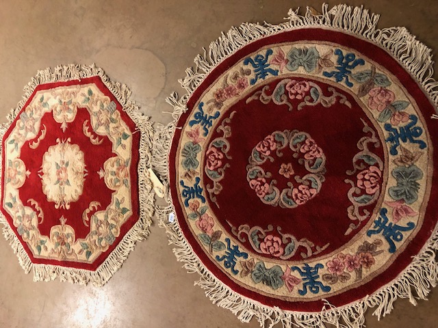 Chinese wool rugs, Two rugs of sculpted style with typical designs of flowers against a red back