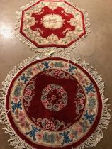Chinese wool rugs, Two rugs of sculpted style with typical designs of flowers against a red back