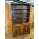 Arts and Crafts oak dresser with shelves above and two cupboards under by maker Curtiss & Sons,