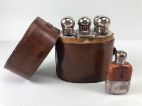 Sporing interest, early 20th century leather cased set of spirit flasks and a small tot flask