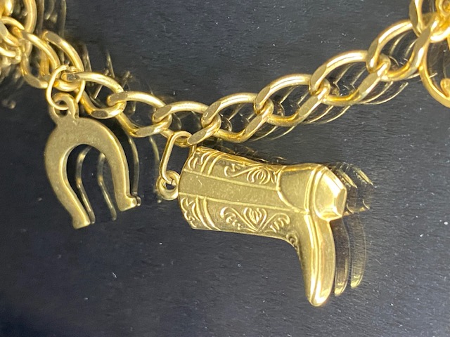 9Ct Gold charm bracelet with a collection of 9ct gold charms, to include, rabbit, Dolphins, Boot, - Image 6 of 9