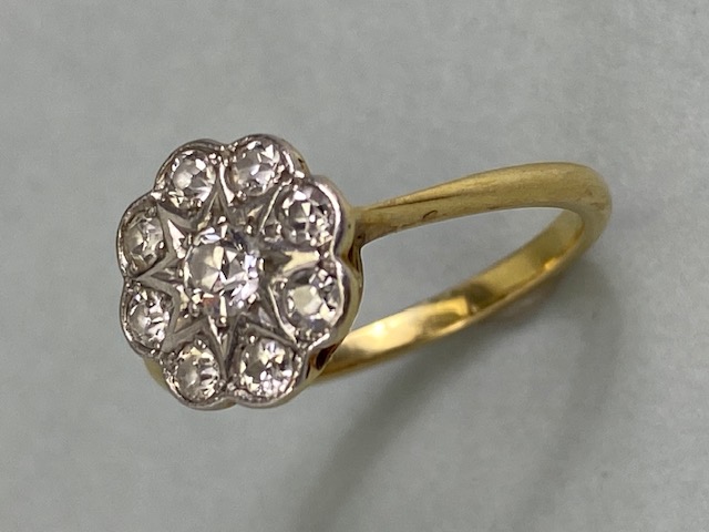 18ct yellow gold daisy cluster ring set with 9 diamonds in white gold approximately 2.4 g size K