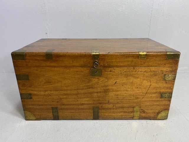Large Campaign travelling trunk with brass bindings and corners and hinged carry handles to sides