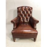 Burgundy leather button back fireside chair with stud detailing and turned front legs