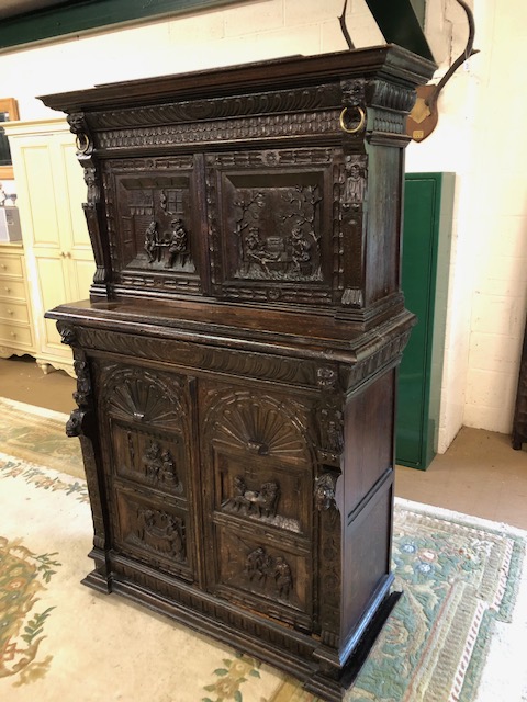 Dresser: late 19th century dark oak continental buffet cupboard, having extensive pictorial carved