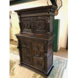 Dresser: late 19th century dark oak continental buffet cupboard, having extensive pictorial carved