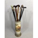 Collection of walking sticks in a ceramic stick stand , various designs, faux amber, faux bone, horn
