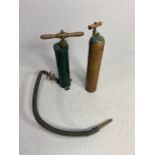 Decorators interest, two antique hand extinguisher pumps, one copper the other metal, with copper