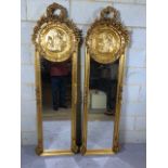 Pair of decorative long Gilt framed dressing or hall mirrors with plaque of pan to the top and