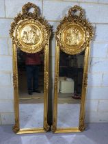 Pair of decorative long Gilt framed dressing or hall mirrors with plaque of pan to the top and