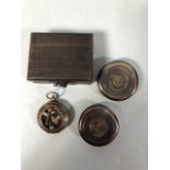 Three brass pocket compasses one in a wooden box