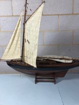 Wooden model of a Sailing yacht, complete with stand, in need of repairs ( masts an keel )