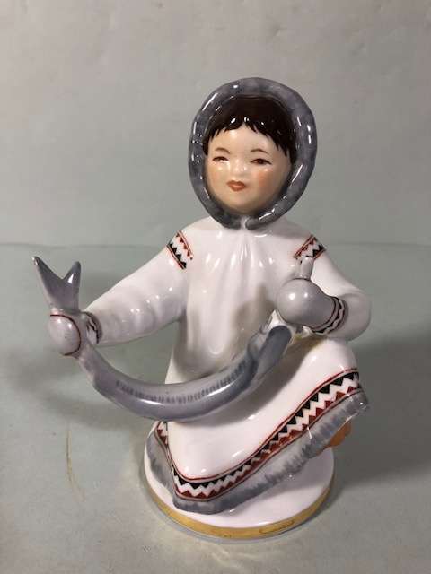 Soviet USSR Lomonosov figure of an Eskimo boy with fish, along with a boy and dog figure (damage