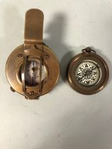 Two brass cased compasses of military style