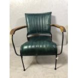 Contemporary style metal framed arm chair with blue green leather upholstery