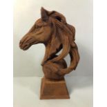 Cast iron statue of a horses head mounted on a ball approximately 45cm high