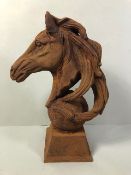 Cast iron statue of a horses head mounted on a ball approximately 45cm high