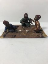 Cold painted bronze of a group of Arabic children playing a Dice game sat on a carpet