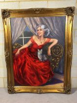 Large Portrait of a Lady wearing a striking red evening dress posed on a shezlong with her cat,