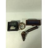 Brass ship style compass in a display box, brass pocket telescope in display box and a fold out