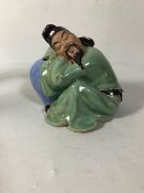 Chinese style figure of a man asleep on a vase approximately 12cm high