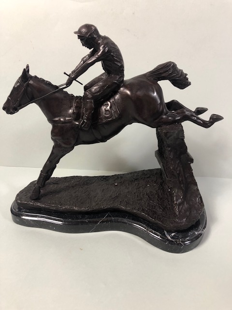 Bronze statue of a race horse and jockey jumping a fence, marble base approximate 32cm high