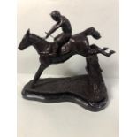 Bronze statue of a race horse and jockey jumping a fence, marble base approximate 32cm high