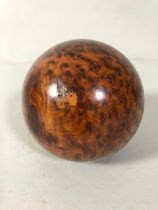 Polished wooden ball made from a tree burr approximately 9cm diameter