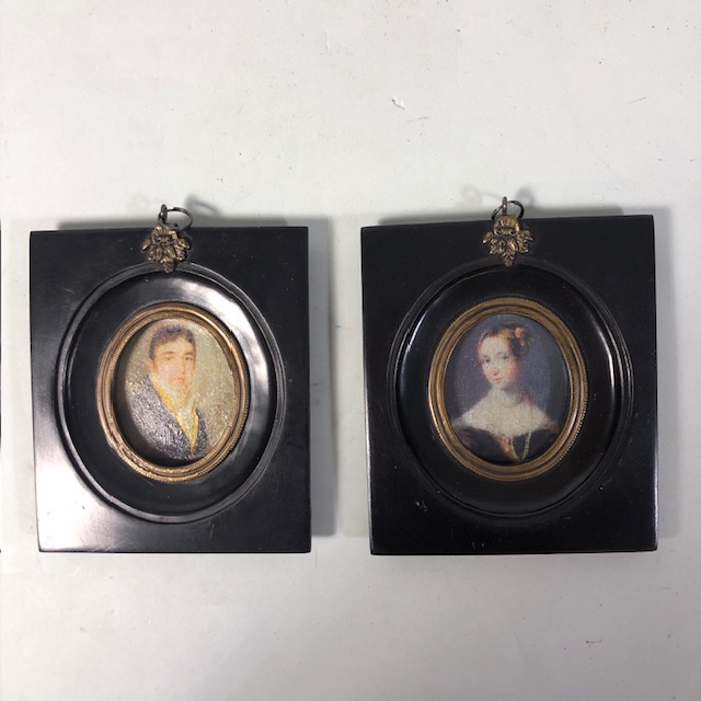 Pair of miniature portraits in black frames approximately 11 x 13 cm
