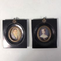 Pair of miniature portraits in black frames approximately 11 x 13 cm