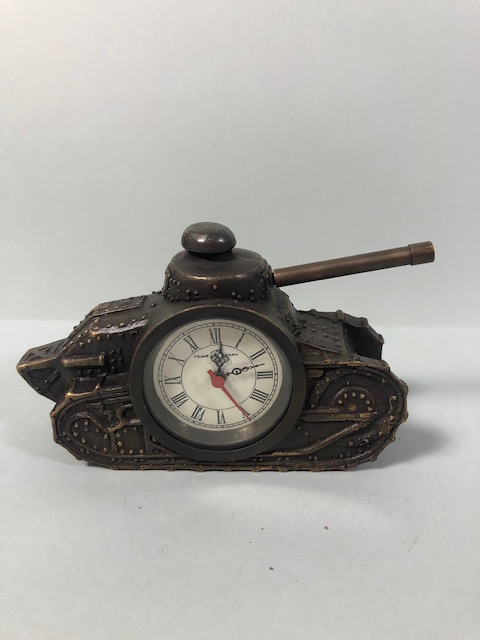 Cast metal clock of bronze finish in the shape of a WW1 tank, winds and runs, approximately 16cm