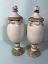 Pair of terracotta lidded urns with pink crackle glaze finish each approximately 48cm high