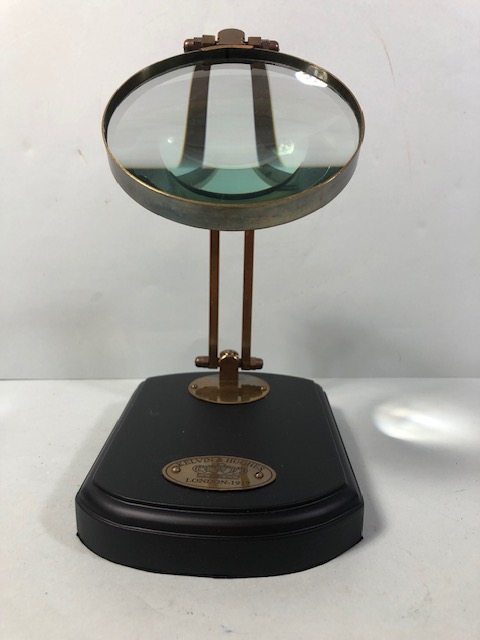 Laboratory style brass framed magnifying glass on wooden base