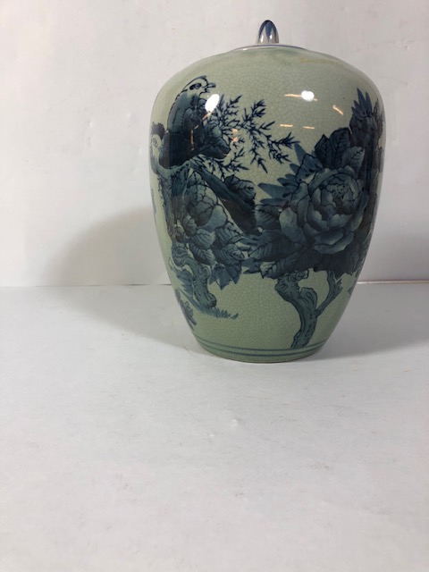 Oriental style vase with designs of birds and flowers, in a blue/green glaze approximately 24cm