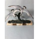 Continental Art Deco Mantel sculpture of 2 gulls soring above the sea, painted metal. mounted on