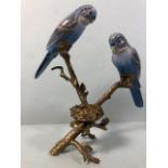 Tea light holder of 2 ceramic birds on a bronze tree branch with a nest approximately 26cm high