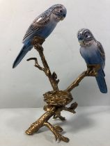Tea light holder of 2 ceramic birds on a bronze tree branch with a nest approximately 26cm high