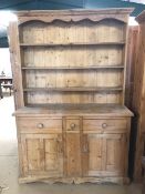 Pine furniture, a 20th century kitchen dresser, the base of twin cupboards with three drawers above,