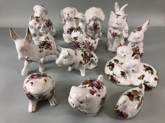 Collectable china figures of various animals each one decorated with flowers 14 in total