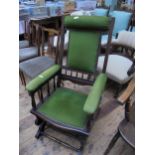 Fabric covered Victorian American rocking chair with spindles and stretchers and on castors
