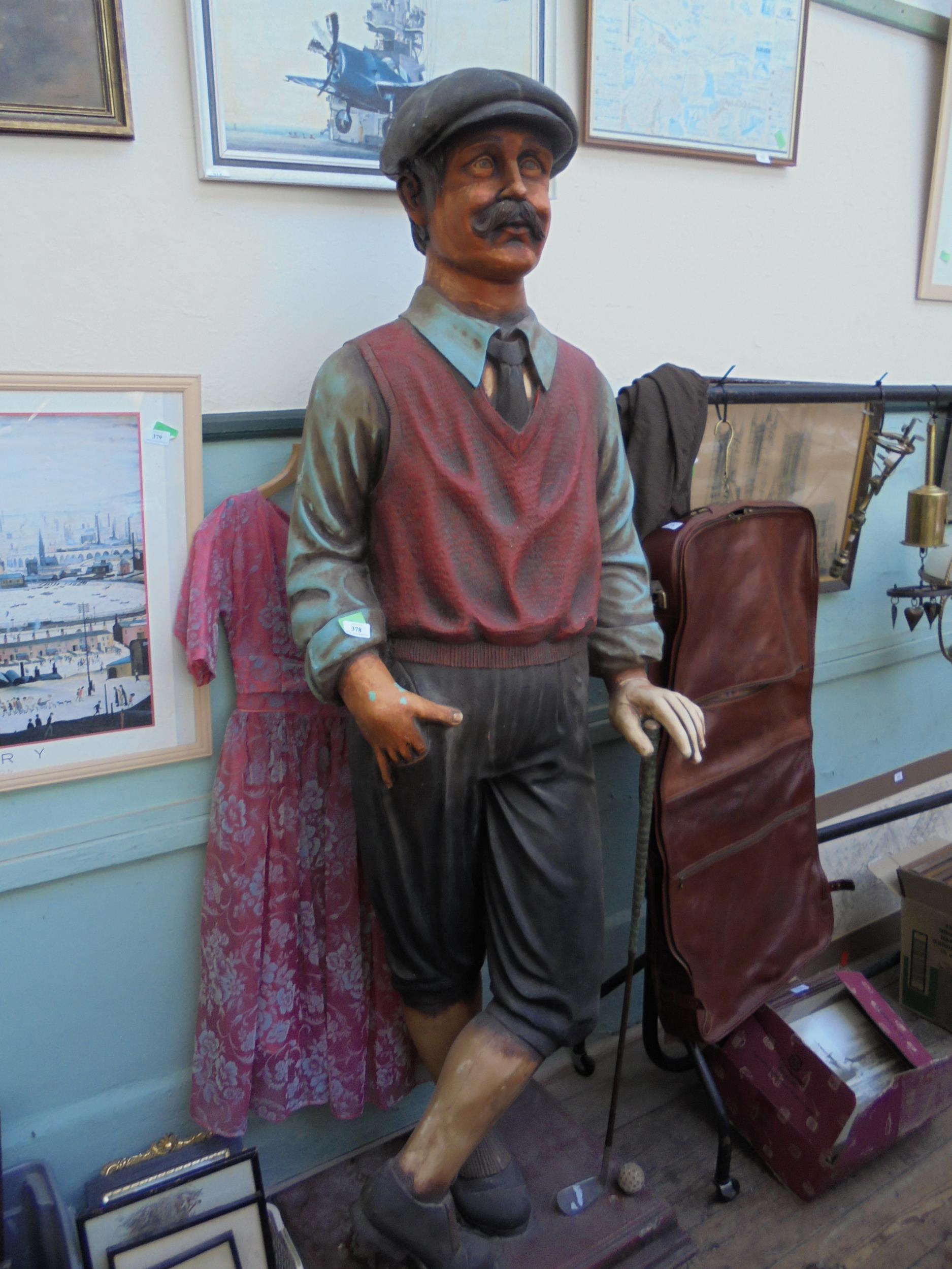 Impressive large fibreglass figure of a golfer with golf club and ball,