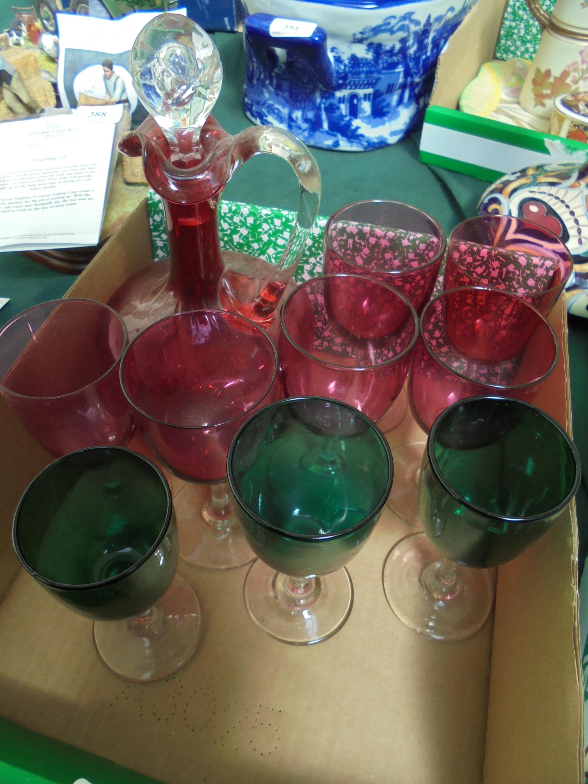 Cut glass cranberry decanter with 6 ruby glasses together with 3 green cranberry style glasses